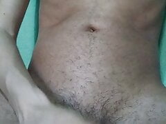 Young hairy skinny sitting on the bed masturbating