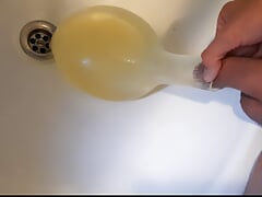 young german twink pissing in condom till its completely full and blown up like a baloon and jerking off after this relief